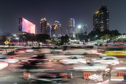 Rush hour captured with blurred motion in the heart of the business district of Jakarta on the gatot Subroto highway in Indonesia capital city at night