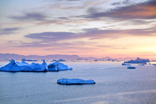 Arctic Icebergs with sunset on Arctic Ocean in Greenland