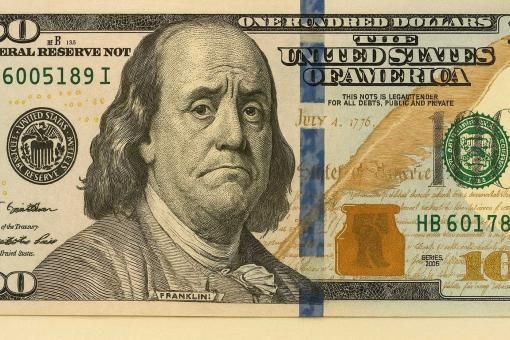 US bank note concept with a frowning Benjamin Franklin